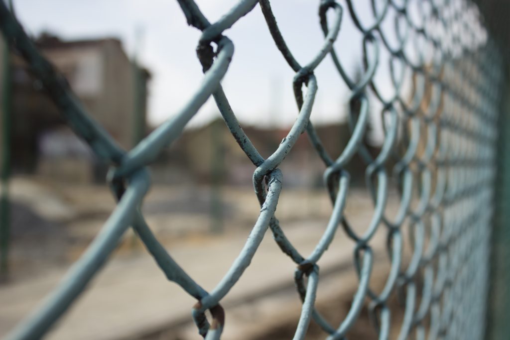 metal fence concept with building construction yard on backgroun